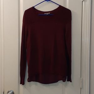 A maroon sweater